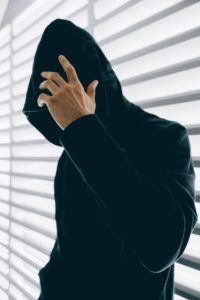 Man in Black Covering His Face