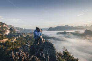 Online Digital Photography Courses: Man on Top of Mountain Taking Pictures